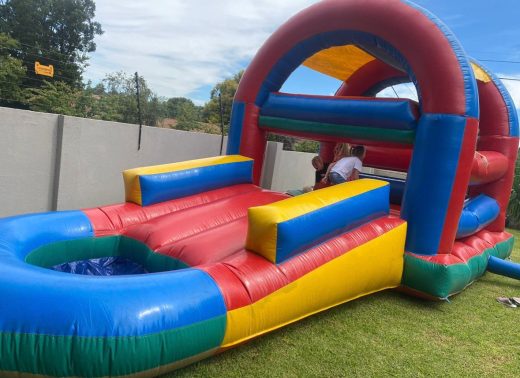 Jumping castle with water slide into pool